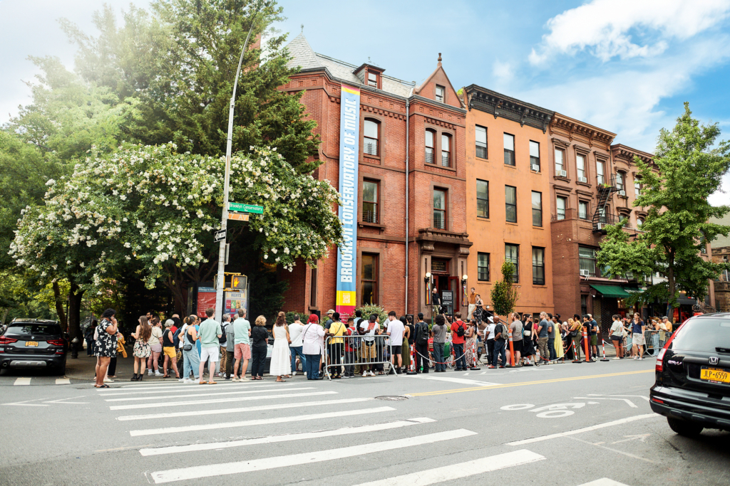 An audience gathered to listen to music outside the Brooklyn Conservatory of Music