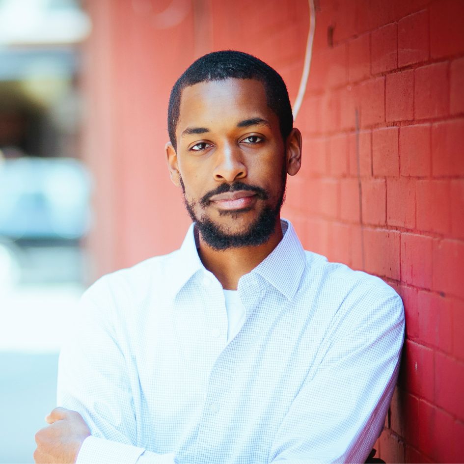 Elijah Thomas standing against a brick wall