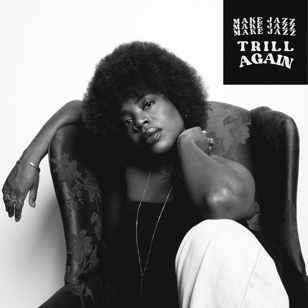 Melanie Charles sitting in an armchair in black and white