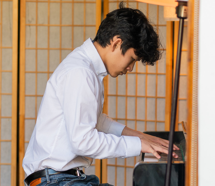 A student playing piano at Open Stages